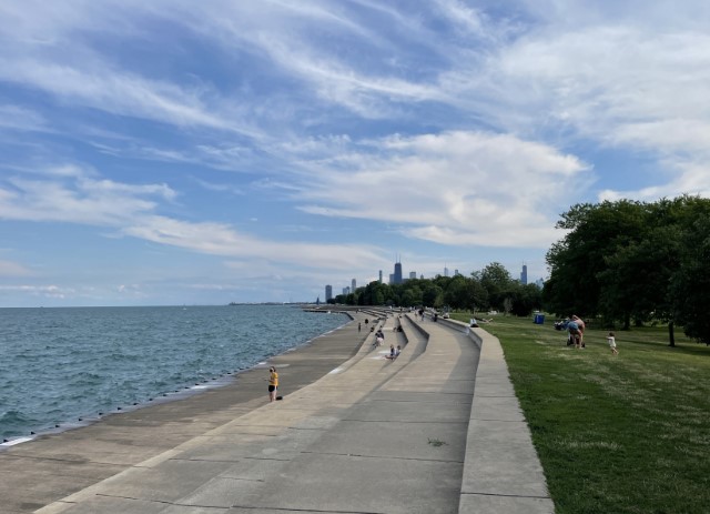 View of Lake Michigan with concrete terraces along the shore and skyscrapers in the distance