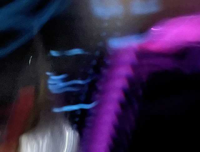 Black background with smears and squiggles and soft shapes in blue and white and purple.
