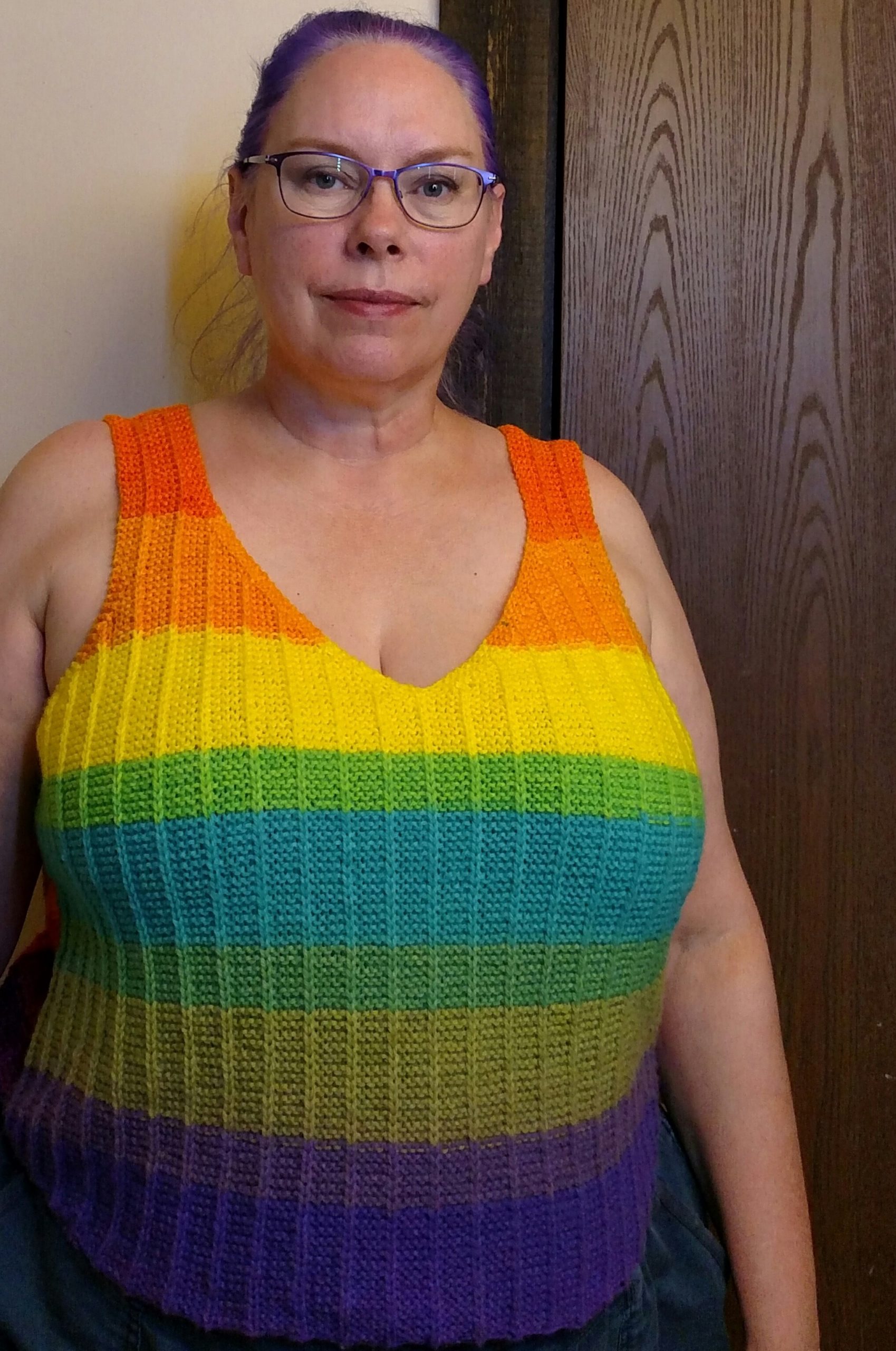 woman wearing a bright striped handknitted tank top